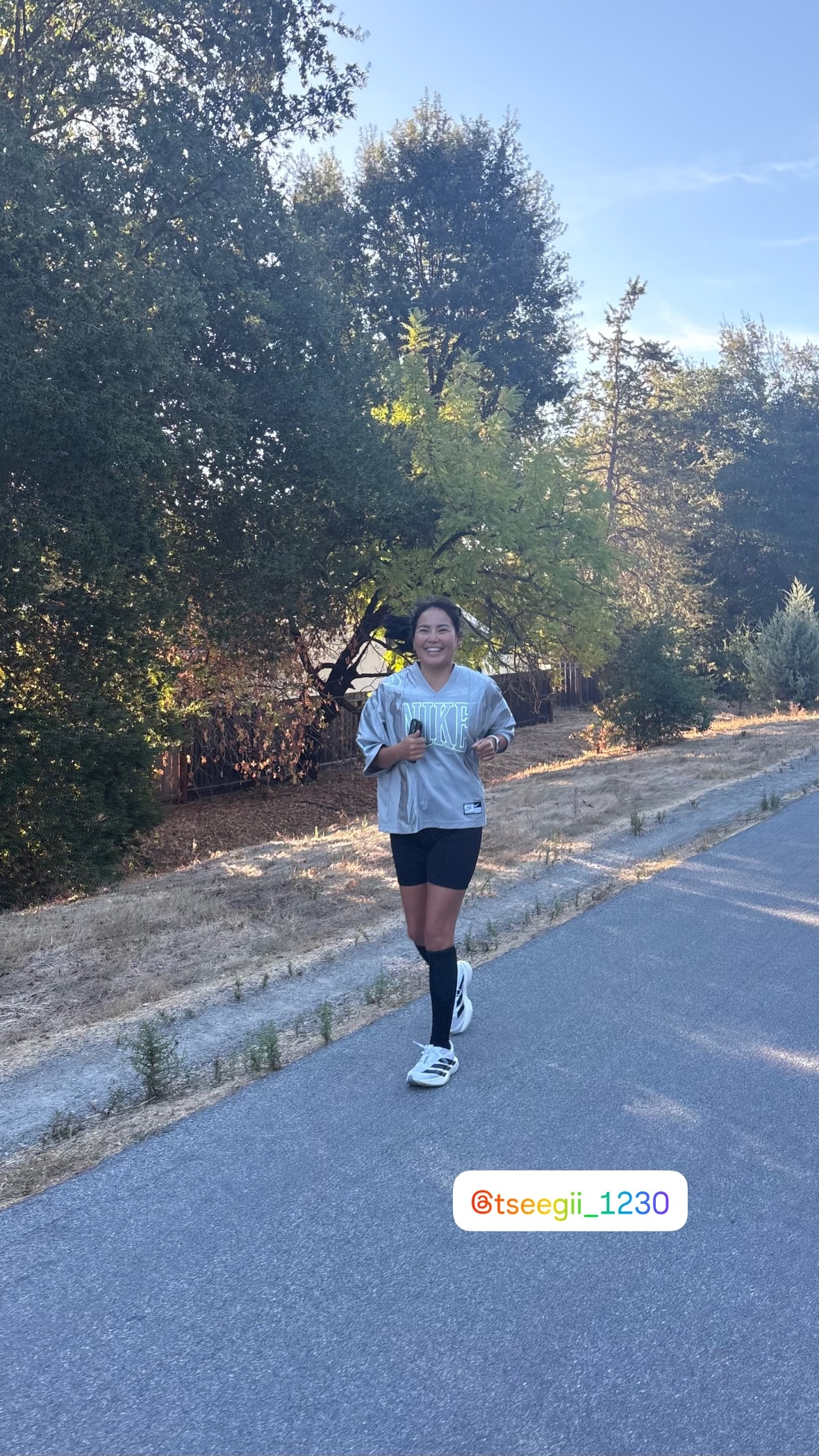 Tseegii smiling as she runs on the paved trail during Saturday Runday